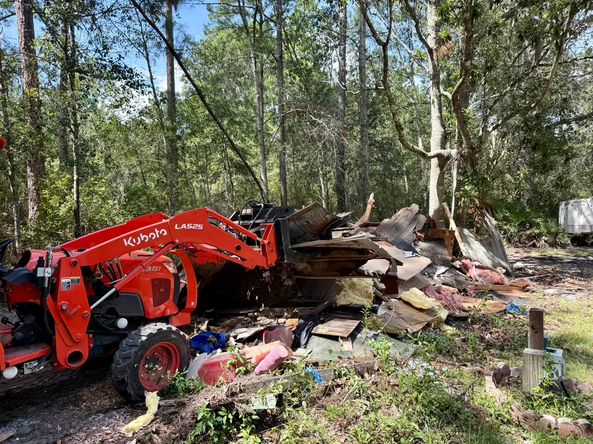 Tractor loading shed demolition debris during the tear-down