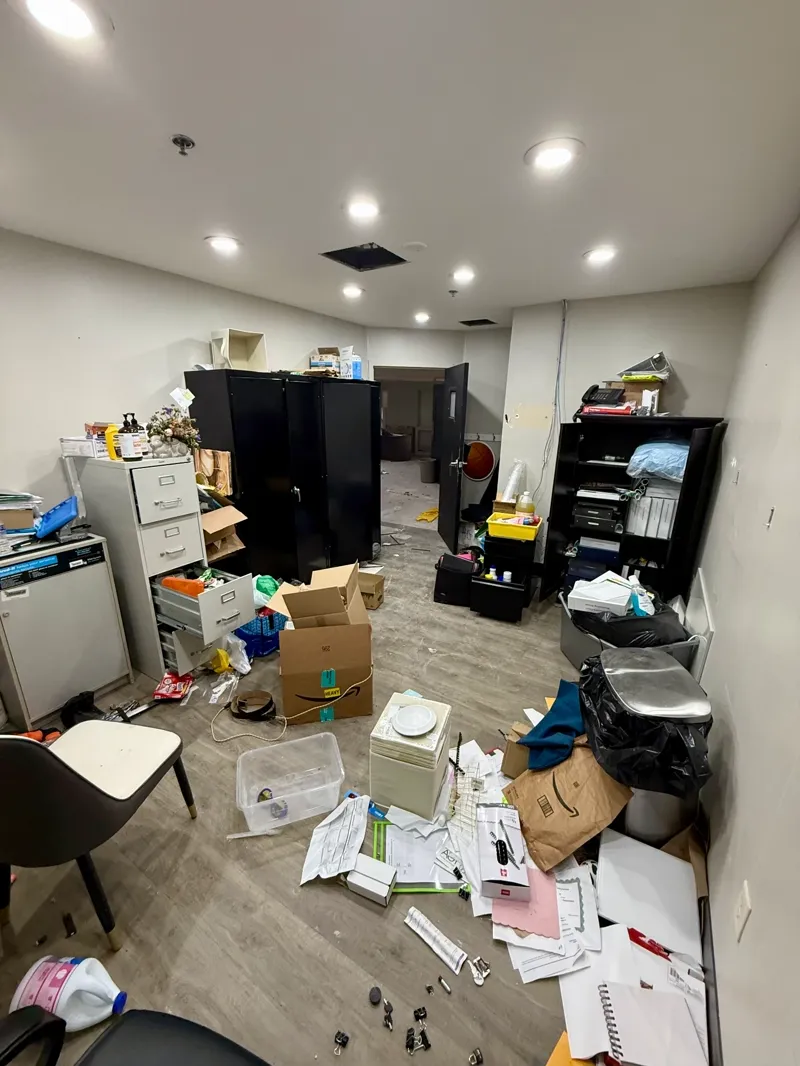 Office interior being cleared of shelving, filing storage, and leftover boxed paperwork