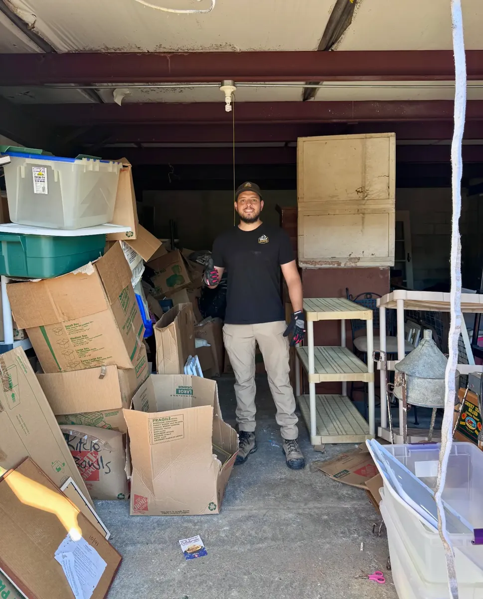 Storage unit packed with boxes, bins, and shelving before the cleanout