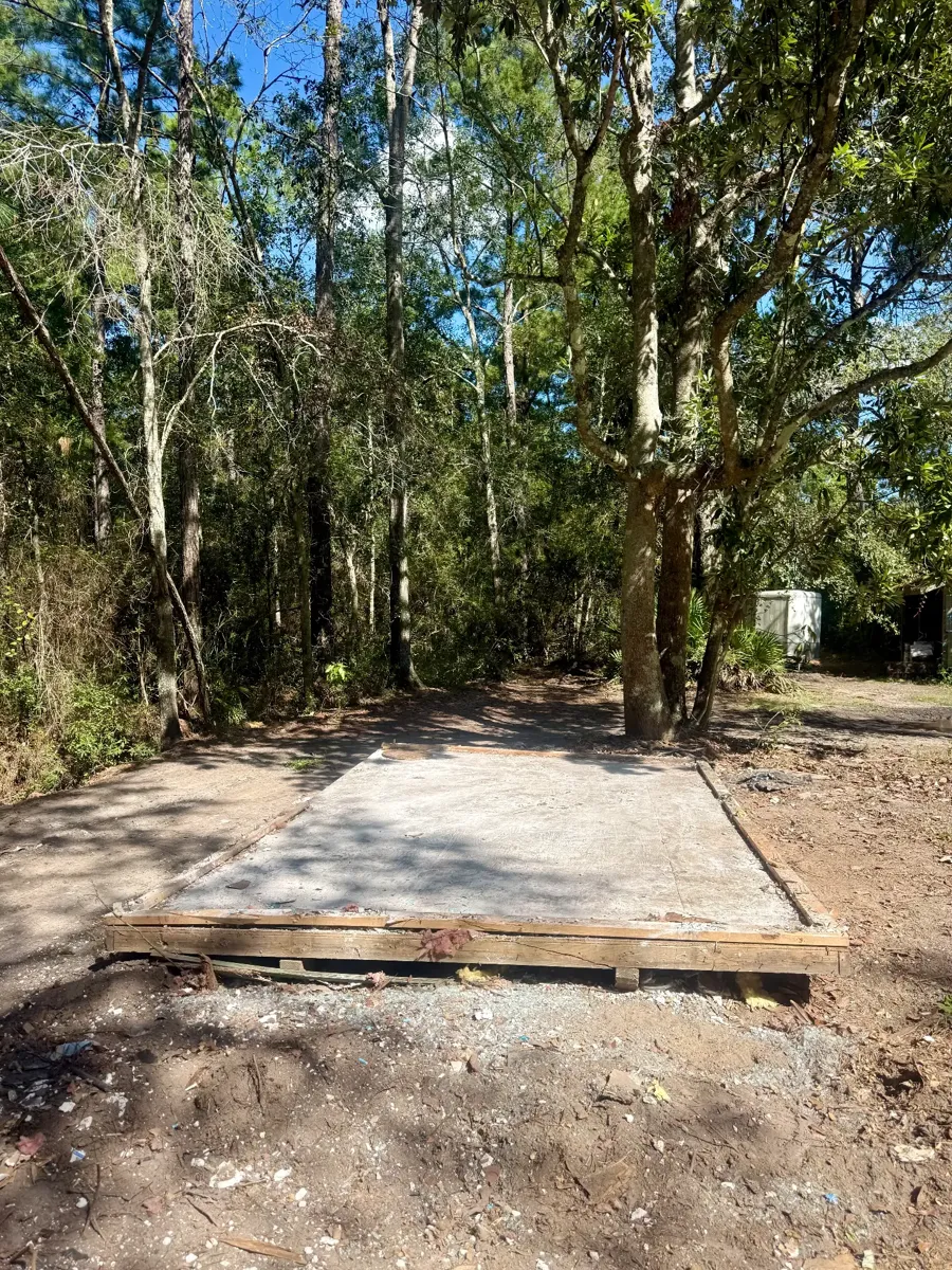 Cleared shed base after demolition and debris haul-away