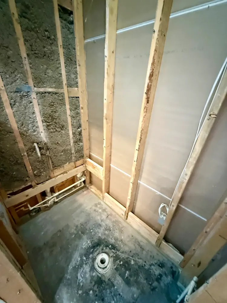 Shower opened to studs and base after tile and bench removal