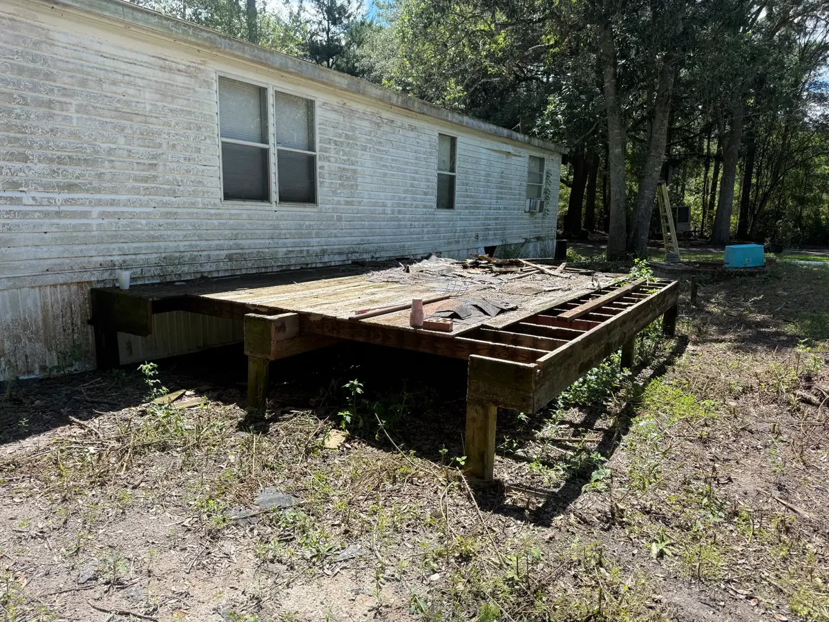 Weathered backyard deck before demolition by Tally Junk Removal and Demolition