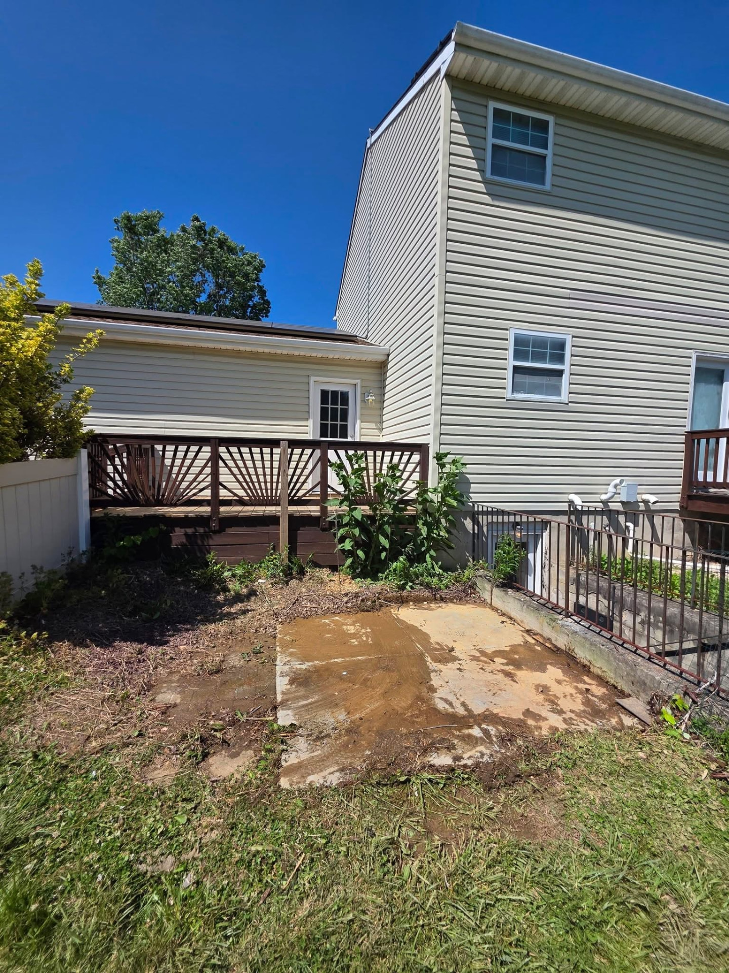 Hot tub removal, after: concrete pad cleared beside the deck with the hot tub hauled away