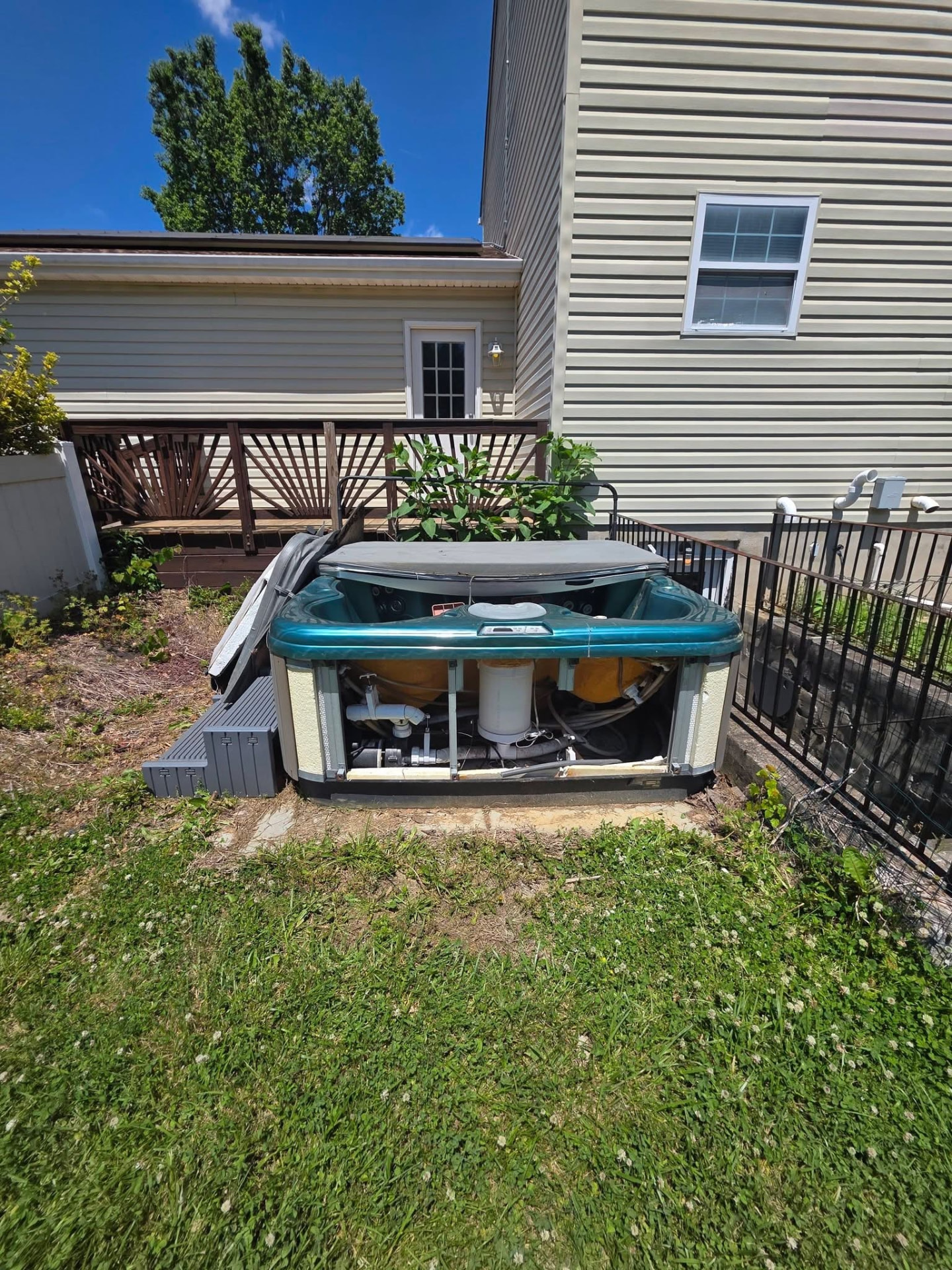 Hot tub removal, before: old hot tub in place beside back deck